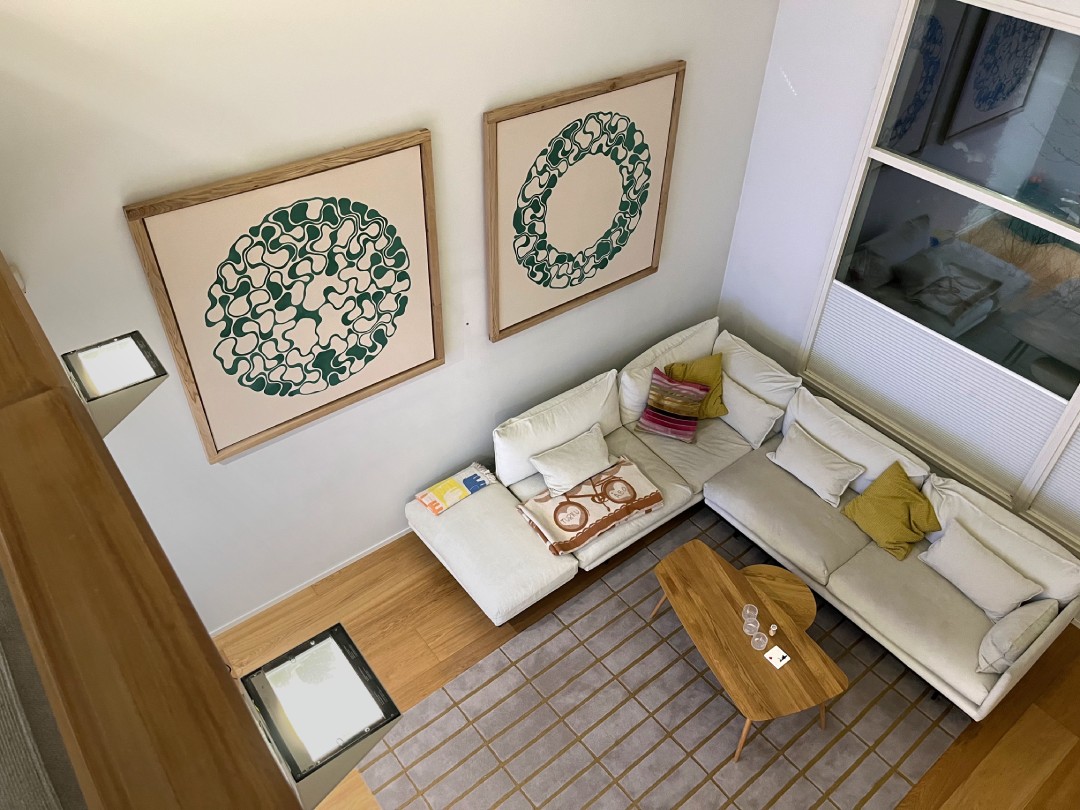 Two large abstract paintings displayed in an architectural interior